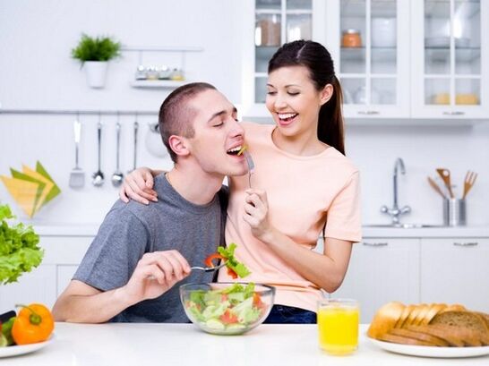 a woman feeds a man with products to increase natural potency